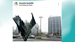 Picture of the Ernst-Reuter-Platz with a sculpture in the foreground and a high-rise with a T logo in the background