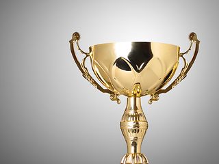Golden Cup against gray background