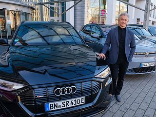 Adel Al-Saleh, Vorstandsmitglied der Deutschen Telekom und CEO von T-Systems, vor E-Auto-Flotte.