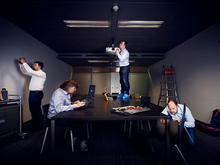 Collage shows people using technical devices to examine a meeting room.