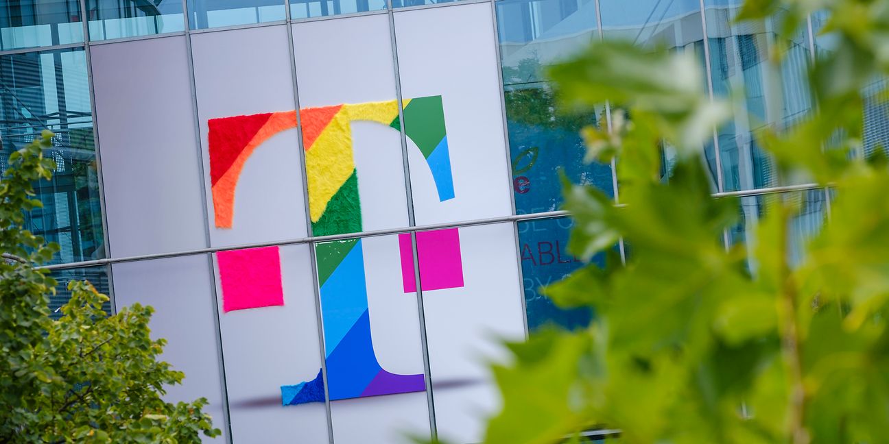 Deutsche Telekom logo in rainbow colors on the facade of an office building 
