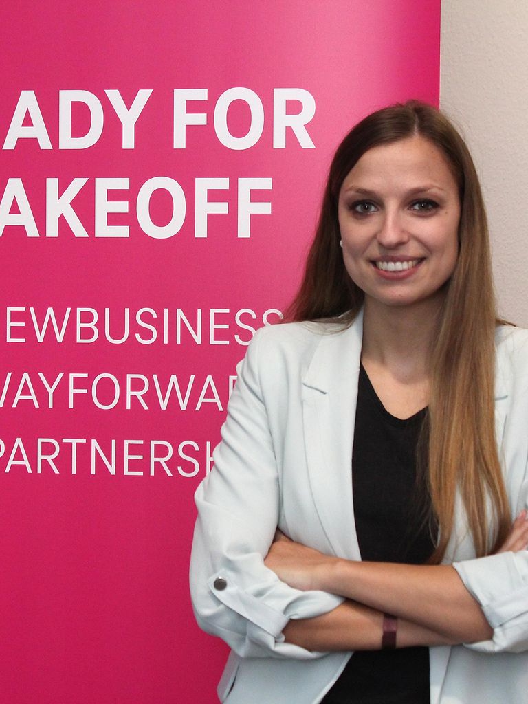 Sophia Hansche in front of a banner that reads "Ready for Takeoff"