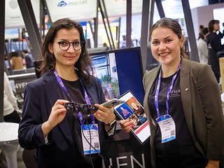 Two women demonstrating augmented reality glasses.
