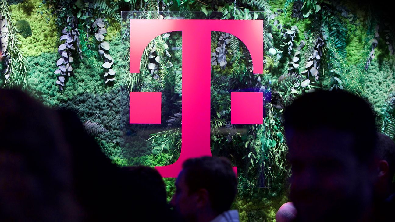 The Deutsche Telekom “T” in magenta in front of a green natur-like background.