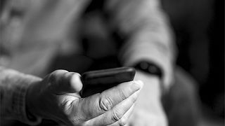 Hands of a man holding a mobile phone