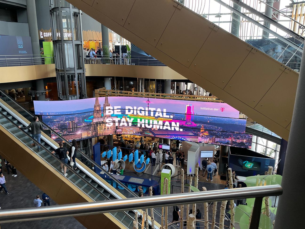 Escalators in a large building, focus on a luminous advertisement 