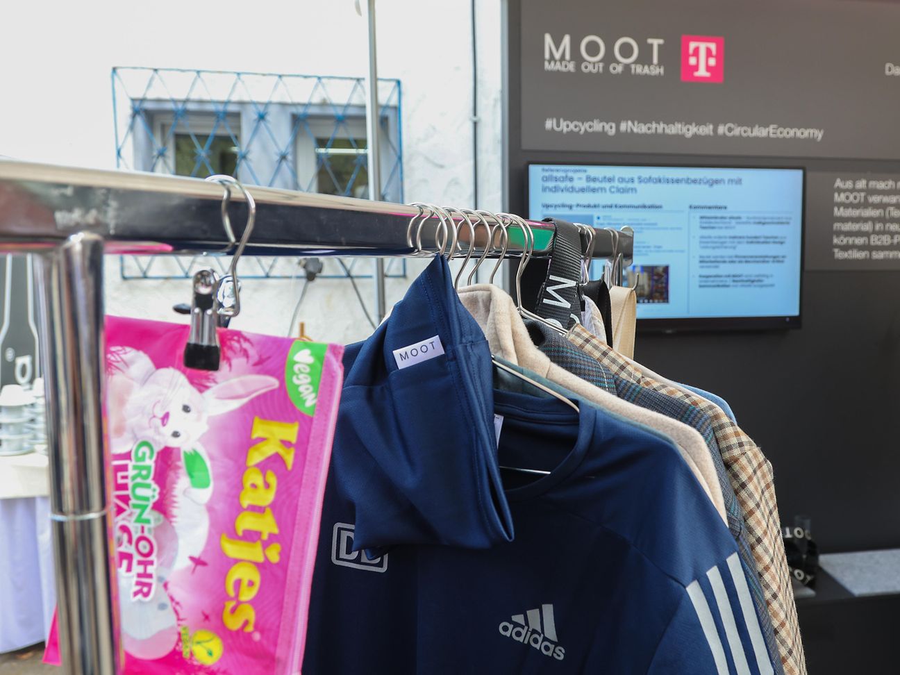 A bag of sweets and clothes on a clothes rack