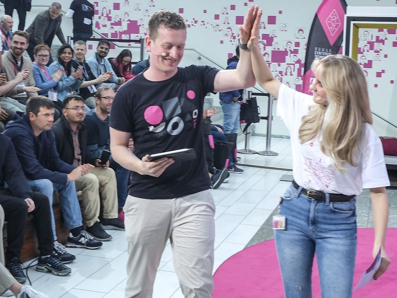 A woman and a man clap their hands