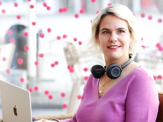 A young woman works on her laptop