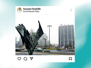 Aufnahme vom Ernst-Reuter-Platz mit einer Skulptur im Vordergrund und einem Hochhaus mit T-Logo im Hintergrund