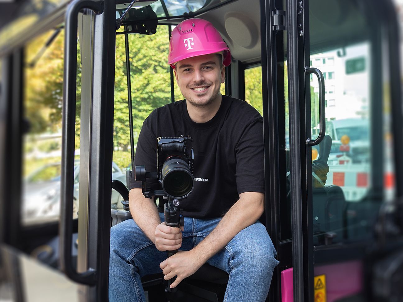Der Volontär Nick Schneider sitzt mit seinem Kamera-Equipment im Cockpit eines Magenta Baggers.