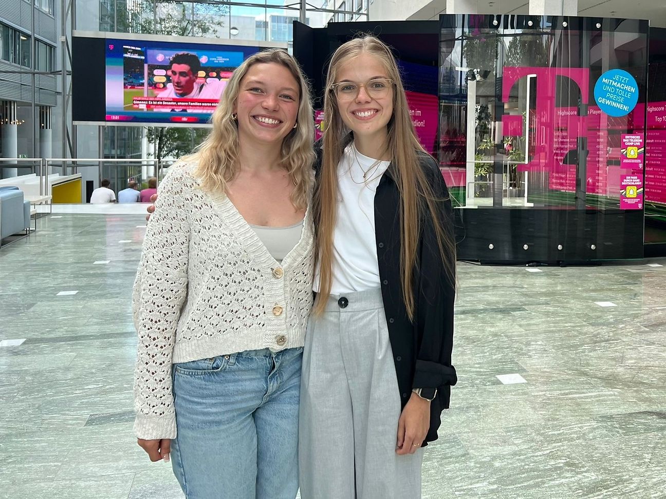 Two young women smile into the camera