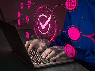 Man in a blue shirt types on a laptop. Icons symbolizing digital services float in the foreground.