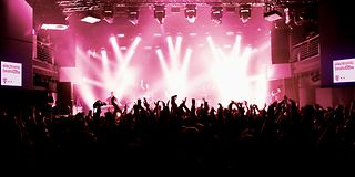 Dancing crowd and DJ in the Electronic Beats concert hall.