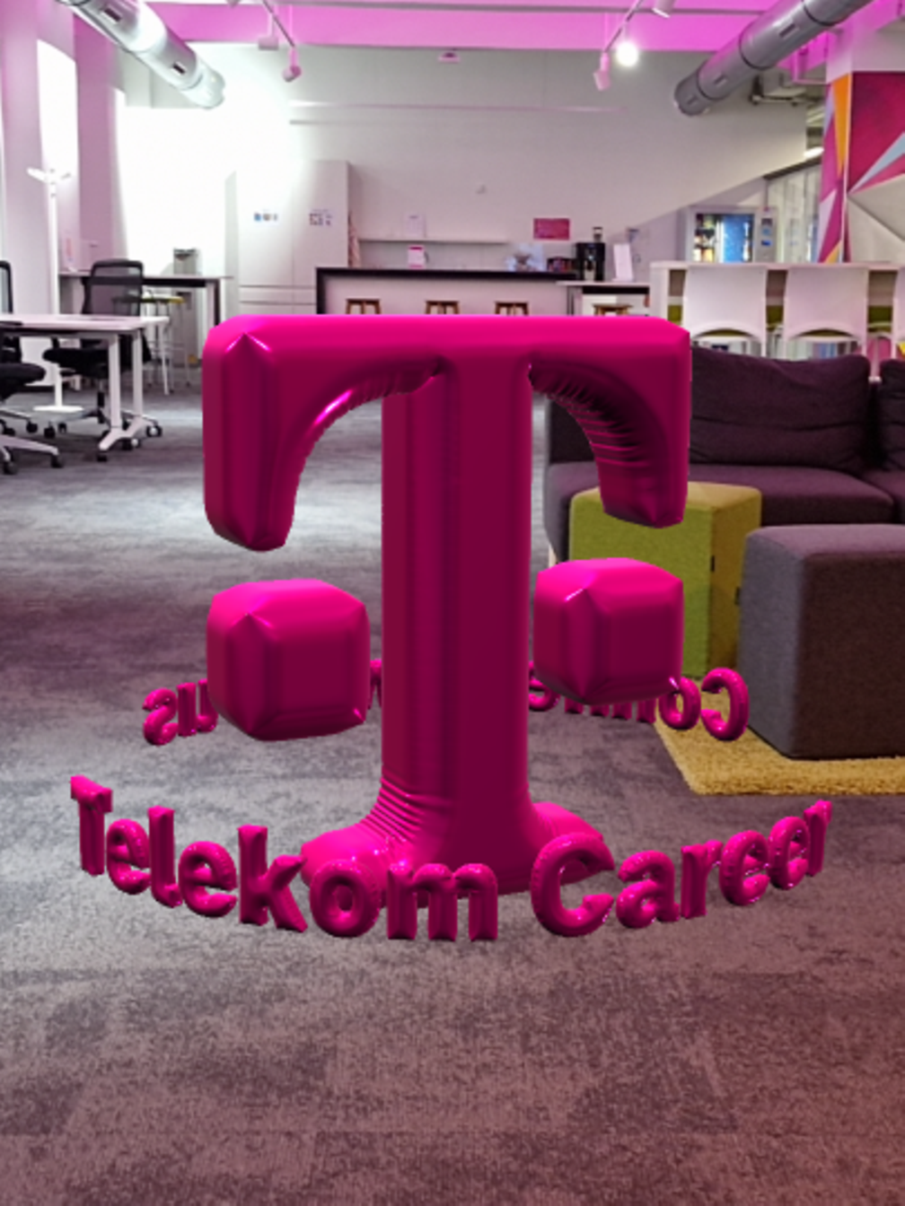 In a office, the T logo floats between furniture as an AR object with a balloon effect in the middle of the room