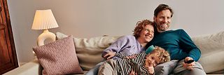 Family sitting on the couch.