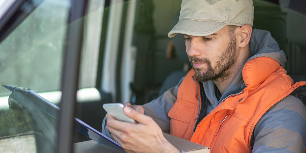 Truck driver looking on his smartphone.