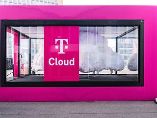 A Telekom container with large ‘Cloud’ lettering. Inside, a large white cloud installation is visible through a glass pane.