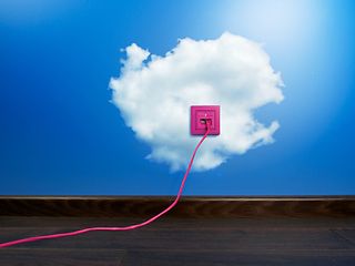 A pink outlet on a blue wall with clouds