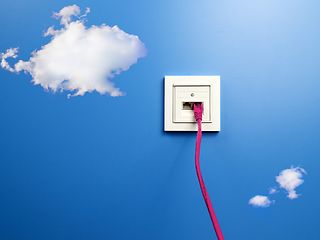 A white outlet on a blue wall with clouds