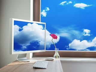 Clouds appear through a window and on a desktop
