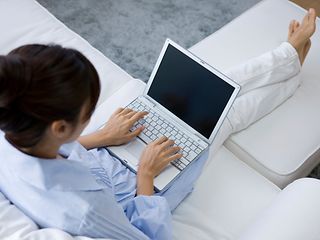 A woman working at laptop.