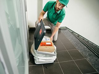 Kurier gibt ein Paket an den PaketButler