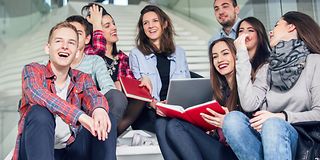 Group of students sitting on stairs.