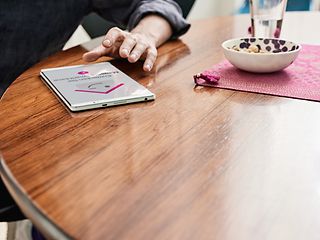 A tablet on a wooden table