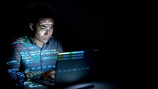 A man in front of a laptop