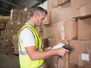 A parcel-deliverer is scanning parcels