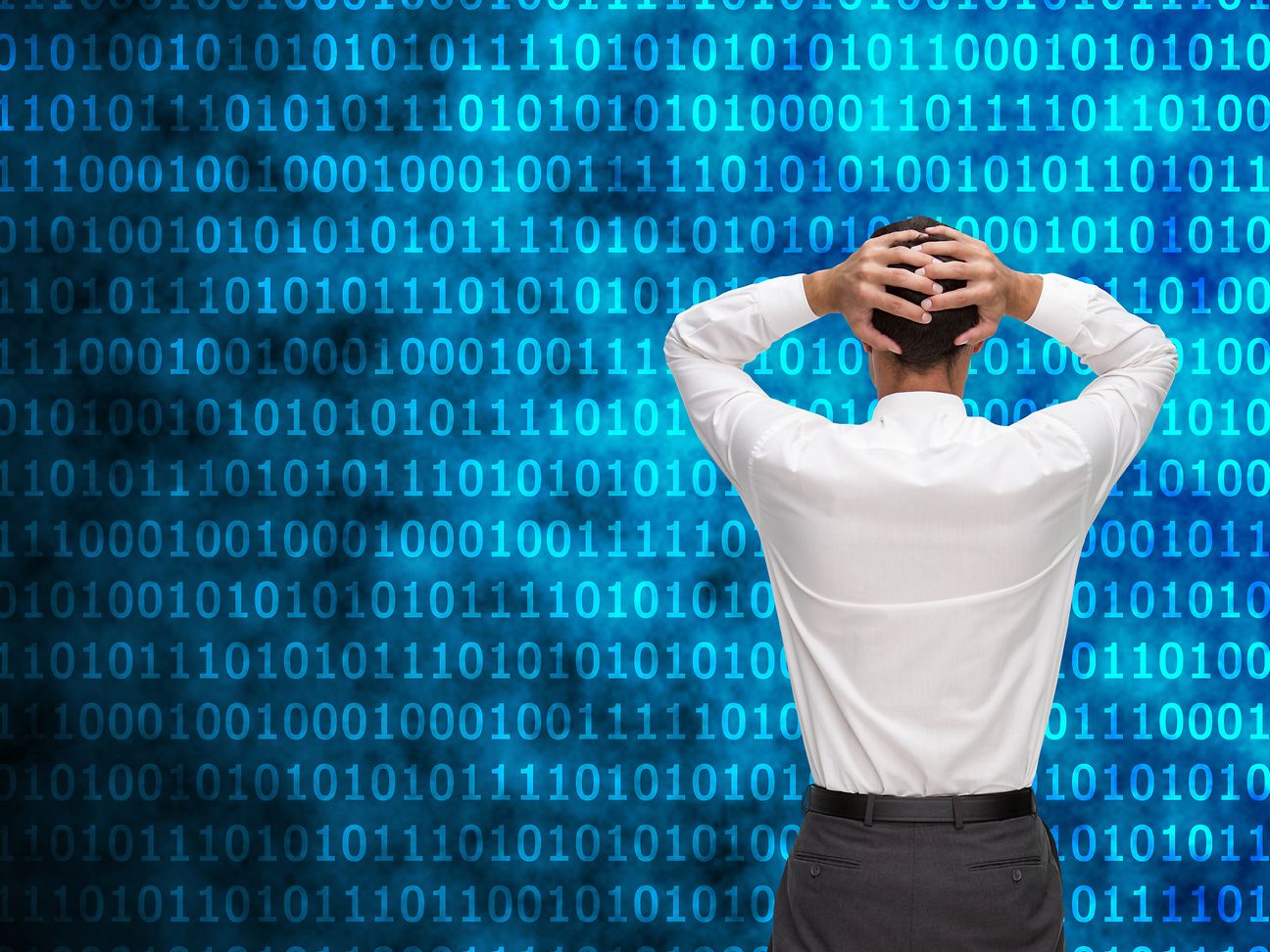 Man tearing his hair in front of matrix wall