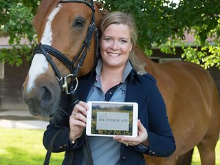 Christina Terbille and her horse Flo. The tablet is displaying her prototype app on screen.