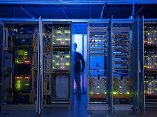 Man behind server racks.