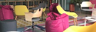 A room with chairs and beanbags.