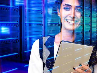 Young woman in the data center with a tablet in her hand