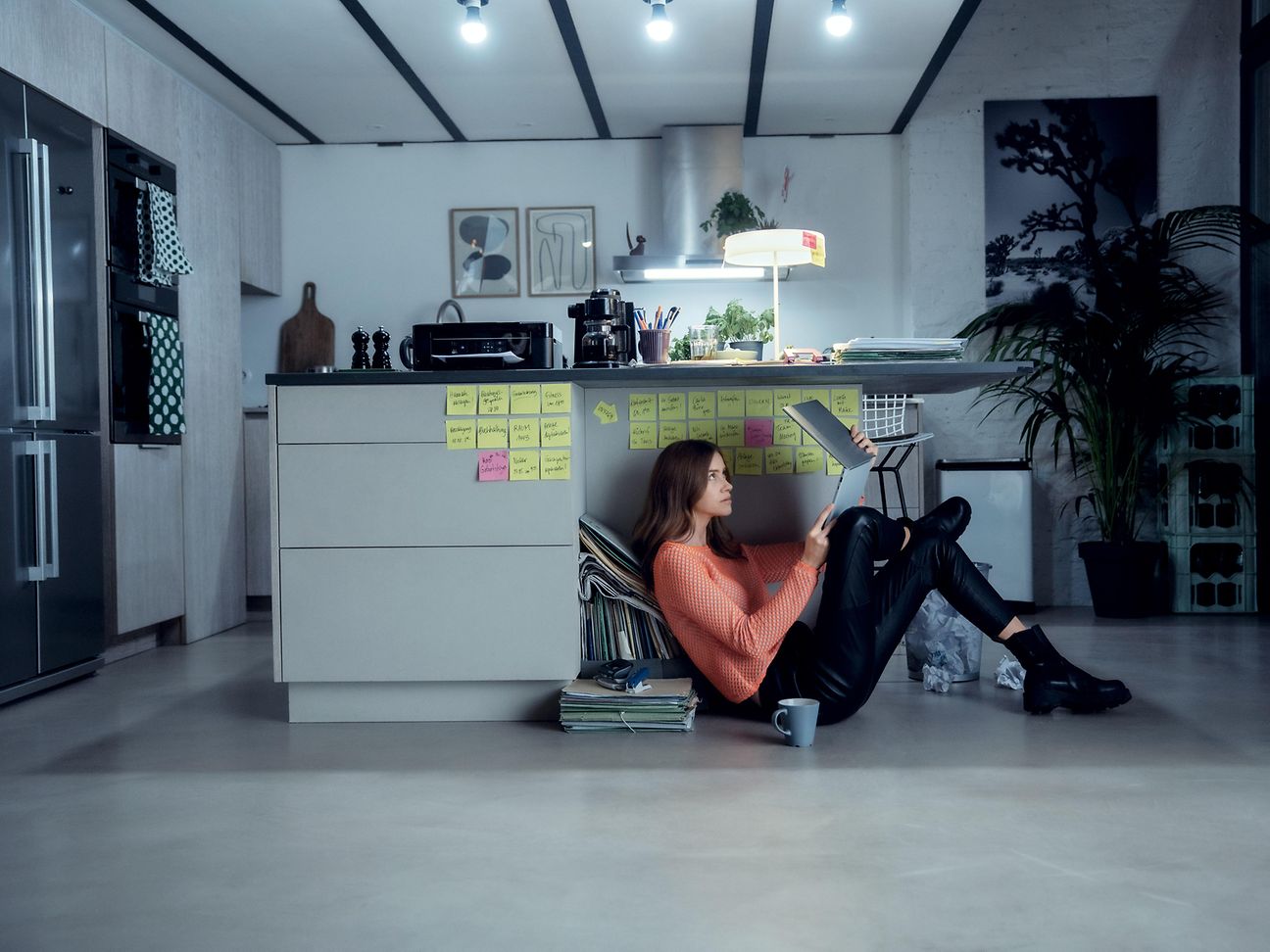 Jugendliche mit Laptop liegt auf dem Sofa.