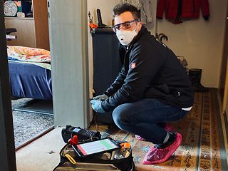 Service technician  Christopher Herz installs the internet access for Horst Heinrich.