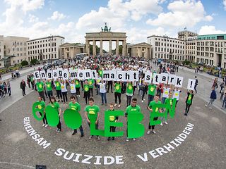 Very many people stand in front of the Brandenburg Gate in Berlin. 