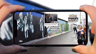 Picture of the Berlin Wall with extra superimposed virtual content.