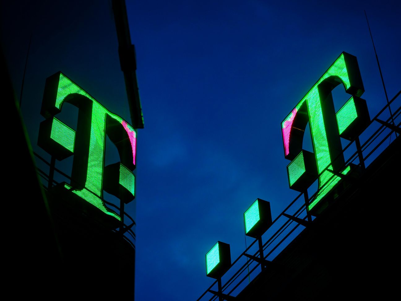 The magenta Logo is overgrown with green leaf animations.