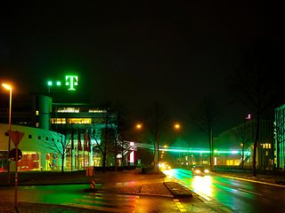 Eye-catcher: The green Group Headquarters at night.
