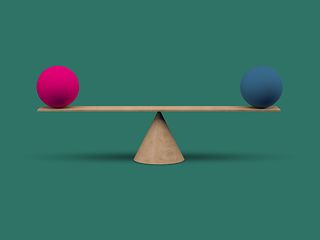 Two balls are balanced on a scale. 