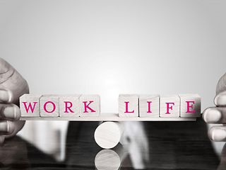 The words Work Life are depicted on 8 cubes. These are balanced on a cylinder