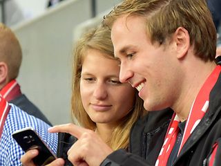 Ein Paar schaut auf ein Smartphone.